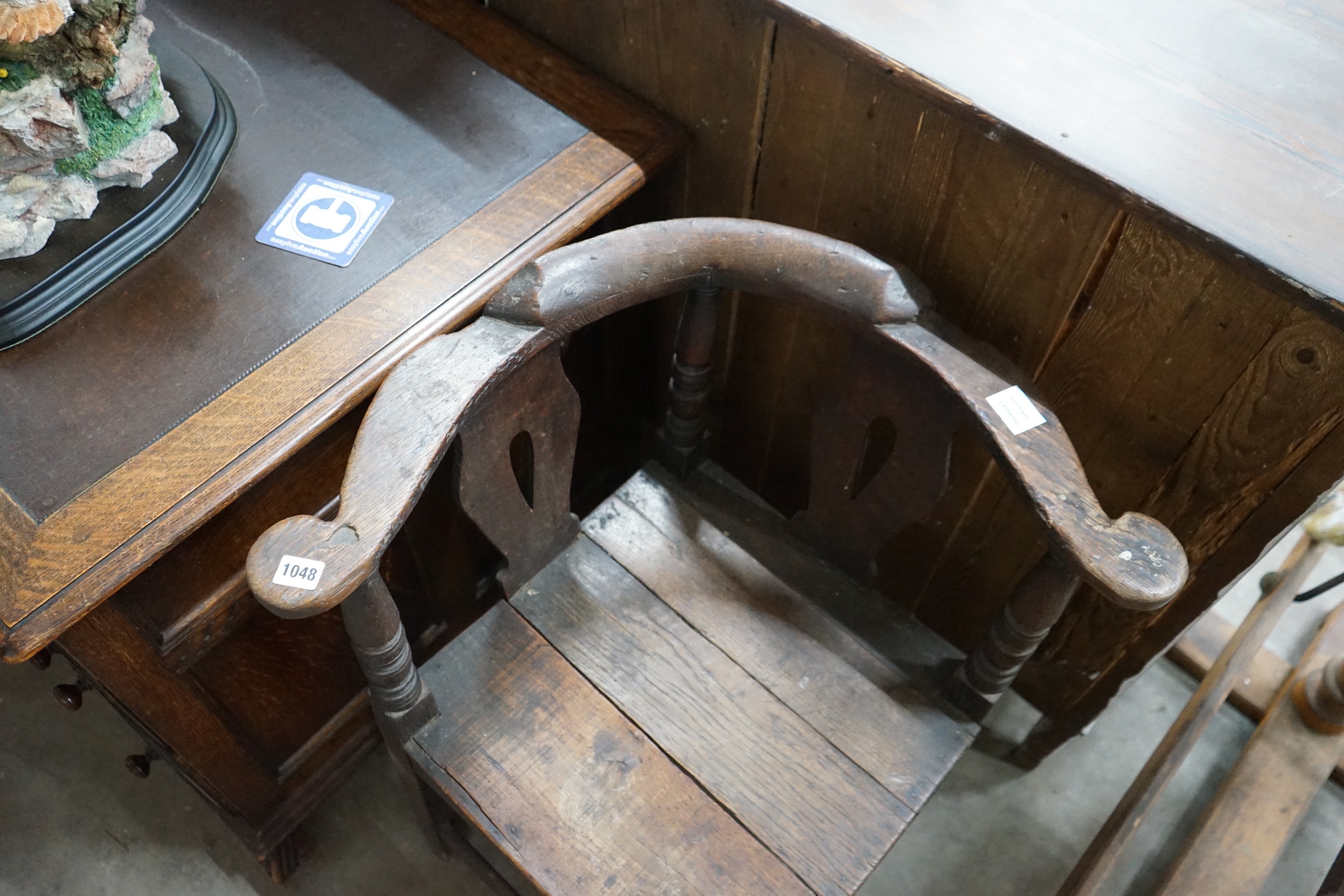 A mid 18th century oak corner elbow chair